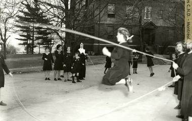 Sister Sainte-Suzanne-Maureen (Suzan O'Halloran) playing skip rope with students at Villa Maria Academy