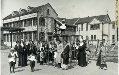 Religious and lay teachers on the playground with the students