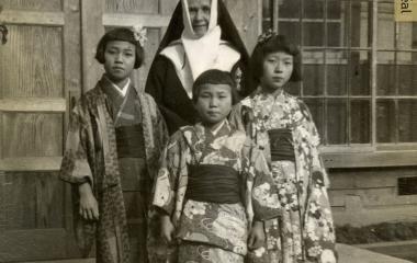 Sister Saint-Gilbert (Rollande Dufresne) and three students wearing their festive kimonos