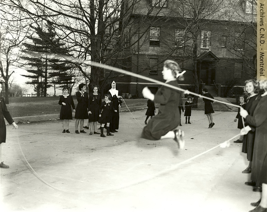 Sister Sainte-Suzanne-Maureen (Suzan O'Halloran) playing skip rope with students at Villa Maria Academy