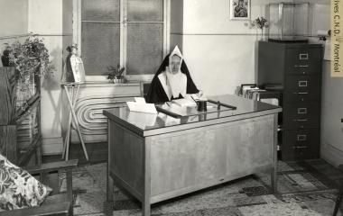 Sister Sainte-Augustina (Lillian Chafe), Superior of Saint Ann Academy, in her office