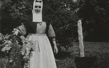 Sister Sainte-Clémence-de-Rome (Louise Dupuis) with a swarm of bees in her lily garden