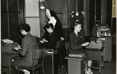 Sister Lucille Goodman supervises the work of the students in the dictaphone lab of Collège de secrétariat Notre-Dame Secretarial College